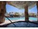 Relaxing hot tub with view of the pool and rock waterfall feature at 8945 Cuban Palm Rd, Kissimmee, FL 34747