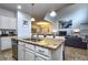 Open kitchen concept with a granite island, stainless steel appliances, and a view of living space at 8945 Cuban Palm Rd, Kissimmee, FL 34747
