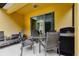 Covered lanai featuring a patio table, chairs, and a grill at 8945 Cuban Palm Rd, Kissimmee, FL 34747