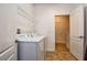 Clean laundry room includes a washer, dryer, and shelving for organization at 8945 Cuban Palm Rd, Kissimmee, FL 34747