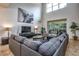 Bright living room with high ceilings, a large sectional sofa, and access to the outdoor patio at 8945 Cuban Palm Rd, Kissimmee, FL 34747