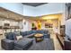 Spacious living room with open layout features a gray sofa, modern decor, and seamless flow to dining at 8945 Cuban Palm Rd, Kissimmee, FL 34747