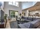 Open-concept living room features a large sectional sofa, a fireplace, and sliding doors to the patio at 8945 Cuban Palm Rd, Kissimmee, FL 34747