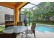 Enclosed patio features a dining area, a small pool, and lush greenery at 8945 Cuban Palm Rd, Kissimmee, FL 34747