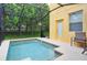 Inviting screened-in pool area with a splash pool and a covered lanai at 8945 Cuban Palm Rd, Kissimmee, FL 34747