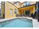 Splash pool area with a covered lanai, seating, and lush surroundings at 8945 Cuban Palm Rd, Kissimmee, FL 34747