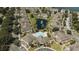 Aerial view of a community featuring a pool, pond, palm trees, and well-maintained landscaping at 9061 Lee Vista Blvd # 1303, Orlando, FL 32829