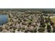 Aerial shot showcases a picturesque community with a central lake, pool, and lush greenery at 9061 Lee Vista Blvd # 1303, Orlando, FL 32829