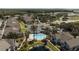 Aerial view of the residences showcasing a community pool, nearby pond, and lush surroundings at 9061 Lee Vista Blvd # 1303, Orlando, FL 32829