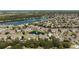 Bird's-eye view of a beautiful community with lush landscaping, sparkling lakes, and a pool at 9061 Lee Vista Blvd # 1303, Orlando, FL 32829