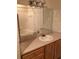 Bright bathroom features a large mirror, vanity with wood cabinets, and tub shower at 9061 Lee Vista Blvd # 1303, Orlando, FL 32829