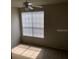 Sunlit bedroom showcasing neutral carpet, a ceiling fan, and a bright window at 9061 Lee Vista Blvd # 1303, Orlando, FL 32829