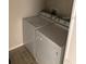 Compact laundry area containing a stacked washer and dryer at 9061 Lee Vista Blvd # 1303, Orlando, FL 32829