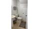 Simple half-bath featuring a pedestal sink, toilet, tile floors, and grey hand towels at 10197 Ridgebloom Ave, Orlando, FL 32829