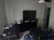 Bedroom featuring a desk, dresser, and TV along with personal items at 10197 Ridgebloom Ave, Orlando, FL 32829