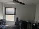 Bedroom with a window, ceiling fan, desk, and dresser with personal items at 10197 Ridgebloom Ave, Orlando, FL 32829