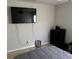 Neat bedroom featuring a gray bed, a wall-mounted TV, and a black dresser at 10197 Ridgebloom Ave, Orlando, FL 32829