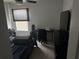 Bedroom with a ceiling fan, window, and desk with personal items at 10197 Ridgebloom Ave, Orlando, FL 32829