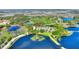 Stunning aerial view of a community with water features and lush green landscaping, perfect for outdoor living at 104 La Cresta Ct, Davenport, FL 33837