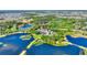 Breathtaking aerial view of a community nestled among serene lakes and lush green spaces, ideal for nature lovers at 104 La Cresta Ct, Davenport, FL 33837
