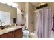 Bathroom featuring granite countertops, vanity, shower, and decorative accents for a stylish retreat at 104 La Cresta Ct, Davenport, FL 33837