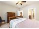 Bedroom showcasing neutral paint, a ceiling fan, wood-look floors, and ensuite access at 104 La Cresta Ct, Davenport, FL 33837