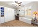 Bedroom/office area with custom built-ins, desk, queen Murphy bed, and bright window with plantation shutters at 104 La Cresta Ct, Davenport, FL 33837