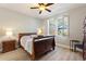 Comfortable bedroom with a ceiling fan, natural light from the windows, and neutral paint at 104 La Cresta Ct, Davenport, FL 33837