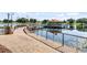 A community dock with a covered gazebo extends into a lake, offering residents a scenic spot for relaxation and enjoyment at 104 La Cresta Ct, Davenport, FL 33837