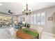 Bright dining area with a chandelier, plantation shutters, and sliding glass doors leading to an outdoor patio at 104 La Cresta Ct, Davenport, FL 33837