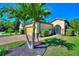 Beautiful home with a well manicured lawn and lush landscaping, including mature palm trees at 104 La Cresta Ct, Davenport, FL 33837