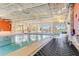 Well-maintained indoor swimming pool with easy access features and ample natural light at 104 La Cresta Ct, Davenport, FL 33837