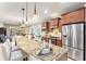 Modern kitchen featuring granite countertops, stainless steel appliances, and a spacious island with seating for dining at 104 La Cresta Ct, Davenport, FL 33837