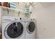 Convenient laundry room featuring a stacked washer and dryer, and shelving for added storage at 104 La Cresta Ct, Davenport, FL 33837