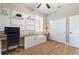 Bright office featuring custom built-ins, desk space, wood-look tile flooring, and a ceiling fan at 104 La Cresta Ct, Davenport, FL 33837
