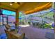 Cozy screened patio featuring brick flooring, a retractable sunshade and comfortable seating area at 104 La Cresta Ct, Davenport, FL 33837