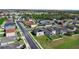 Expansive aerial view of a suburban neighborhood showcasing modern homes and well-manicured lawns on a sunny day at 1246 Maplebrook Dr, Lake Alfred, FL 33850