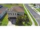 Aerial view of a home featuring solar panels, a well-maintained lawn, and a spacious driveway at 1246 Maplebrook Dr, Lake Alfred, FL 33850