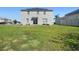 Backyard with a spacious green lawn, offering plenty of space for outdoor activities at 1246 Maplebrook Dr, Lake Alfred, FL 33850