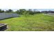 Expansive backyard features a large lawn and white fence, offering privacy and space at 1246 Maplebrook Dr, Lake Alfred, FL 33850