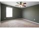 Cozy bedroom featuring neutral walls, carpet, and a ceiling fan for comfortable living at 1246 Maplebrook Dr, Lake Alfred, FL 33850