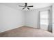 Bright bedroom featuring neutral carpet and walls and natural light through the windows at 1246 Maplebrook Dr, Lake Alfred, FL 33850