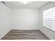 Bedroom features modern gray wood floors and natural light at 1246 Maplebrook Dr, Lake Alfred, FL 33850
