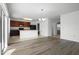 Bright open floor plan with modern kitchen, wood floors, and a chandelier at 1246 Maplebrook Dr, Lake Alfred, FL 33850