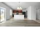 Bright open floor plan with modern kitchen, wood floors, and sliding doors at 1246 Maplebrook Dr, Lake Alfred, FL 33850