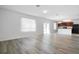 Open concept living area with modern kitchen, wood floors, and large windows at 1246 Maplebrook Dr, Lake Alfred, FL 33850