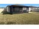 Spacious backyard with a screened-in patio, perfect for outdoor relaxation and entertainment at 1249 Oak Valley Dr, Auburndale, FL 33823