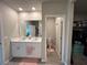 A double sink vanity and separate toilet area provide space in this well-appointed ensuite bathroom at 1249 Oak Valley Dr, Auburndale, FL 33823