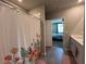 Bright bathroom showcasing a tiled floor, and easy access to the main bedroom via an open doorway at 1249 Oak Valley Dr, Auburndale, FL 33823