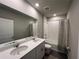 Bright bathroom features a double sink vanity, large mirror, and shower-tub combination with modern design at 1249 Oak Valley Dr, Auburndale, FL 33823